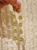 Olive green glass spinel and white pearl woven bracelet with gold-plated copper spacers