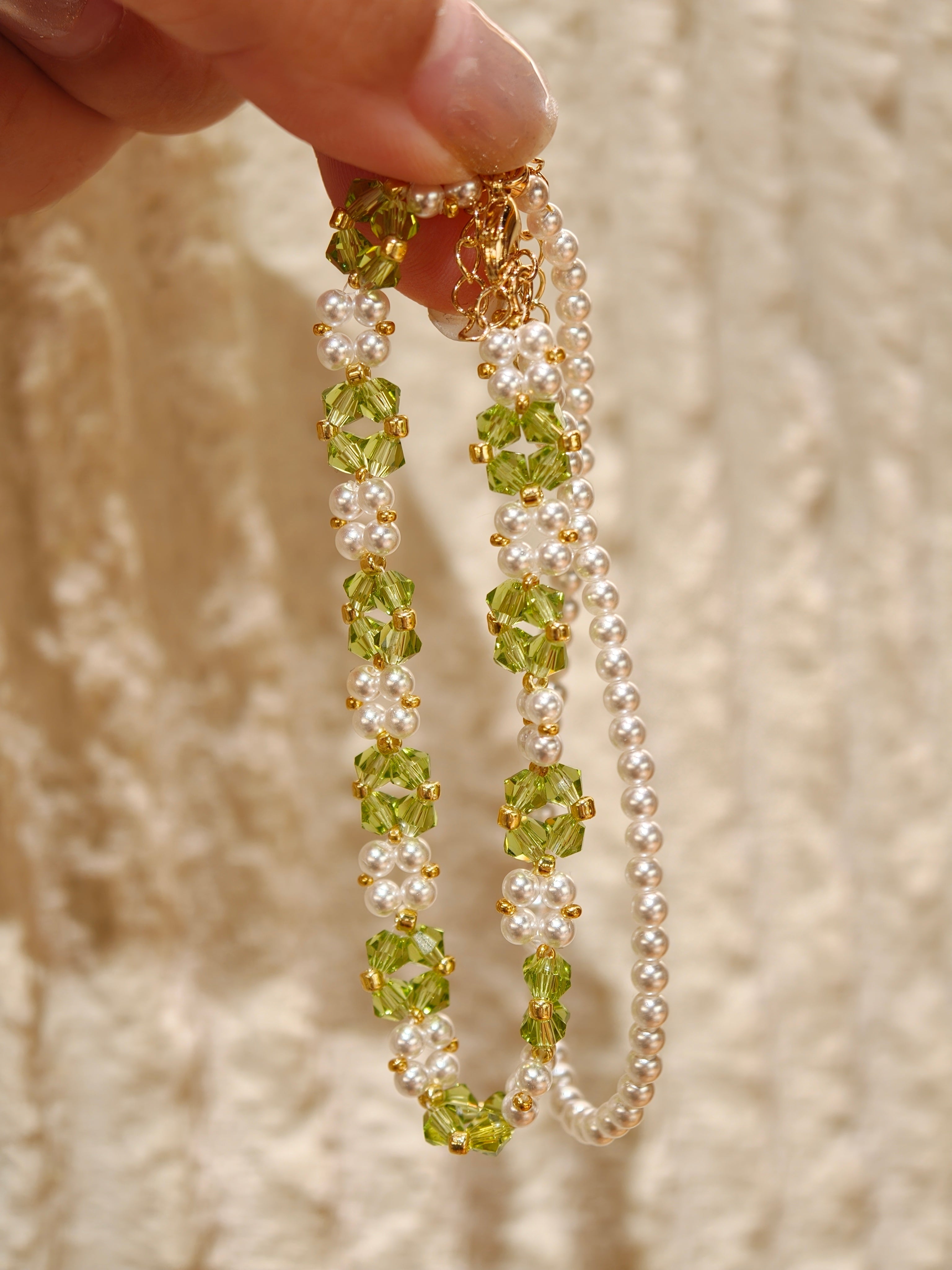 Olive green glass spinel and white pearl woven bracelet with gold-plated copper spacers