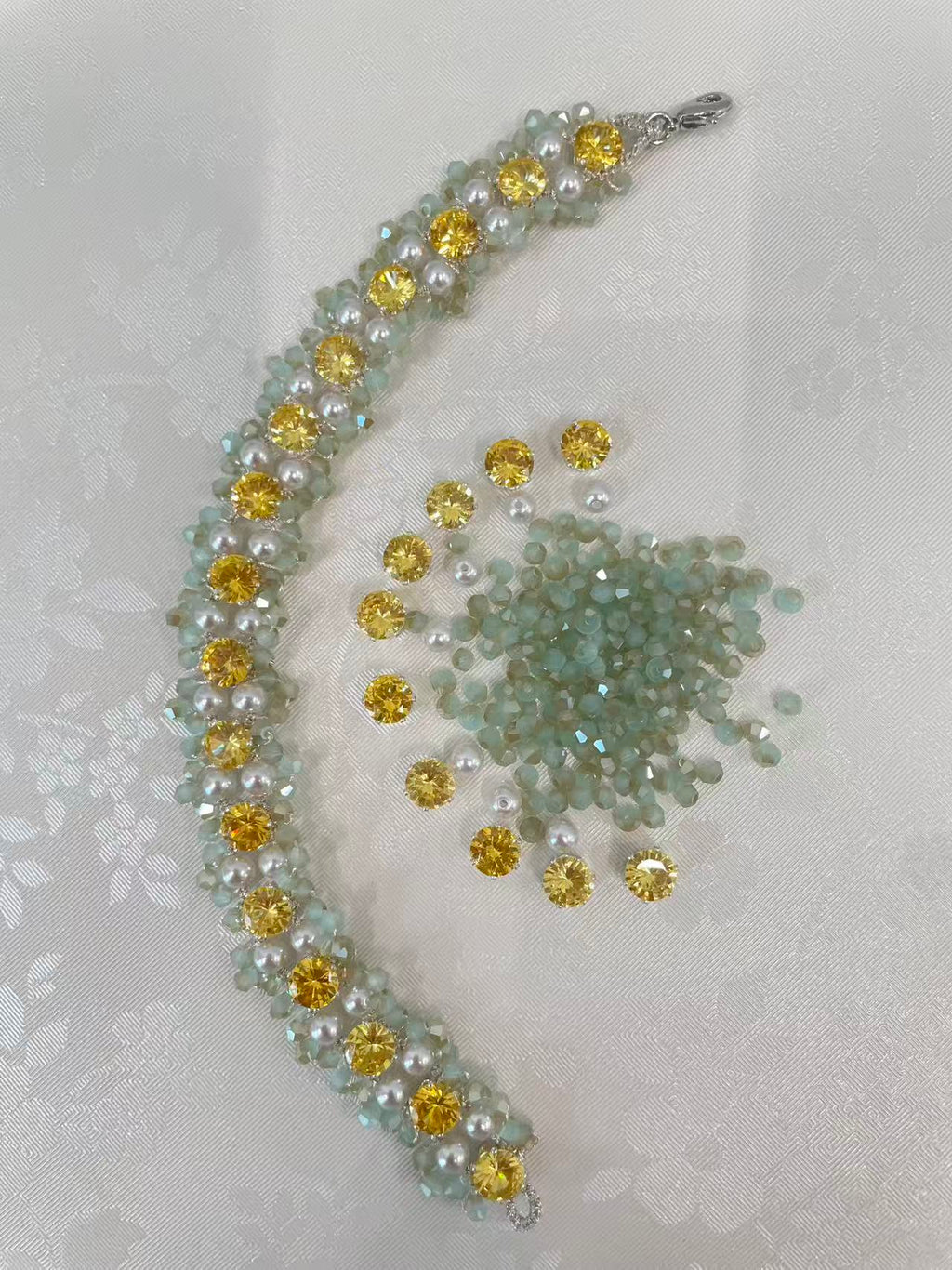 Lumière Weave Bracelet close-up showing tatting detail with loose crystals and beads