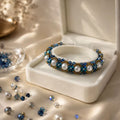 Blue crystal and pearl beaded bracelet in a white jewelry box